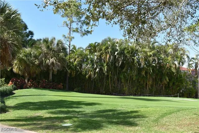 a view of a swimming pool and lounge chairs