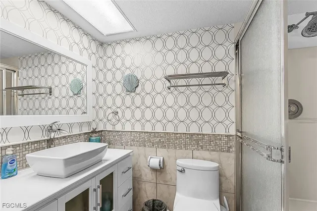 a bathroom with a sink toilet and shower