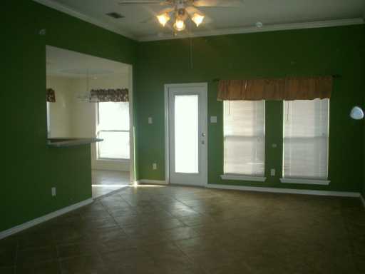 13965 Windjammer Drive Corpus Christi, TX 78418 - Photo 3 of 10 an empty room with wooden floor and windows