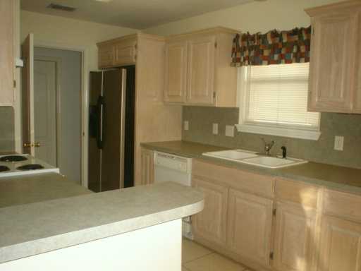 13965 Windjammer Drive Corpus Christi, TX 78418 - Photo 4 of 10 a kitchen with a sink stove and refrigerator