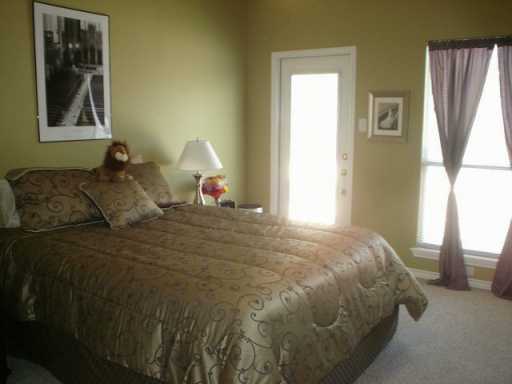 13965 Windjammer Drive Corpus Christi, TX 78418 - Photo 7 of 10 a bed sitting in a bedroom next to a window
