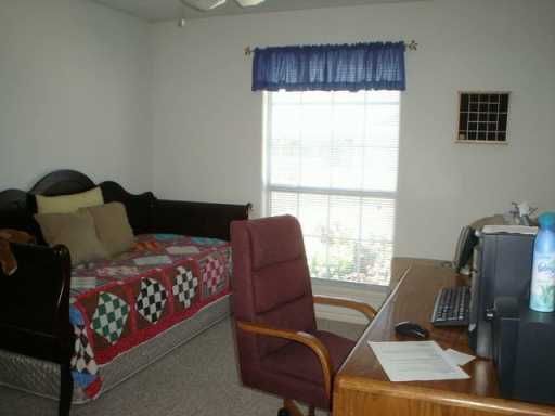 13965 Windjammer Drive Corpus Christi, TX 78418 - Photo 8 of 10 a bedroom with furniture and a window