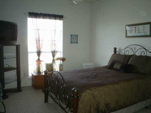 13965 Windjammer Drive Corpus Christi, TX 78418 - Photo 9 of 10 a bed sitting in a bedroom next to a window