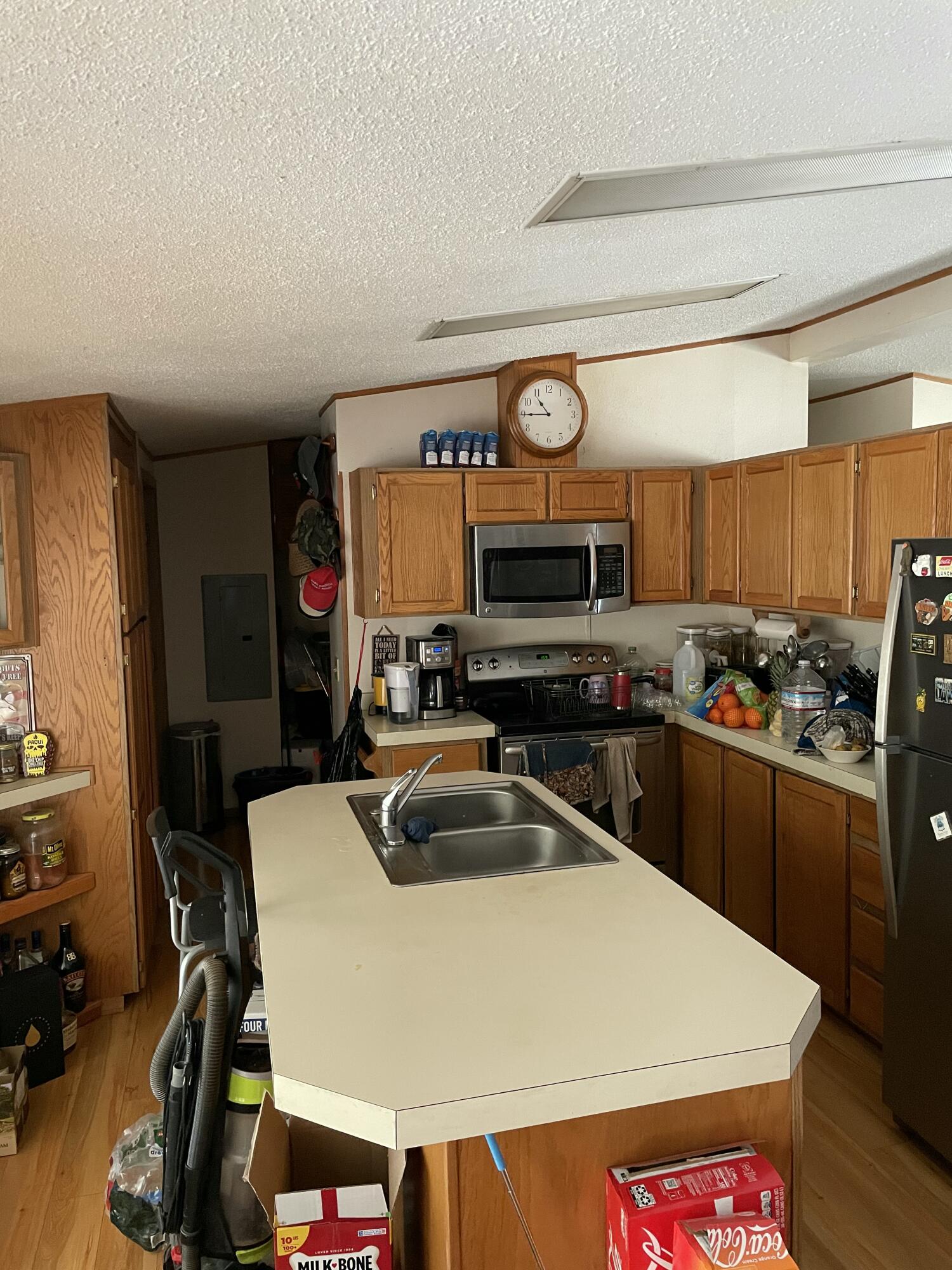 190 Citadel Road Trail, OR 97541 - Photo 4 of 27 a kitchen with a sink a stove and wooden cabinets