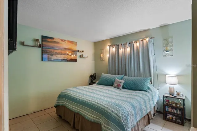 a bedroom with a bed and a lamp