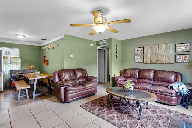 a living room with furniture a rug and a window