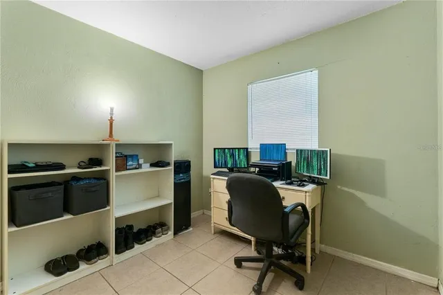 a view of a workspace with furniture and a window