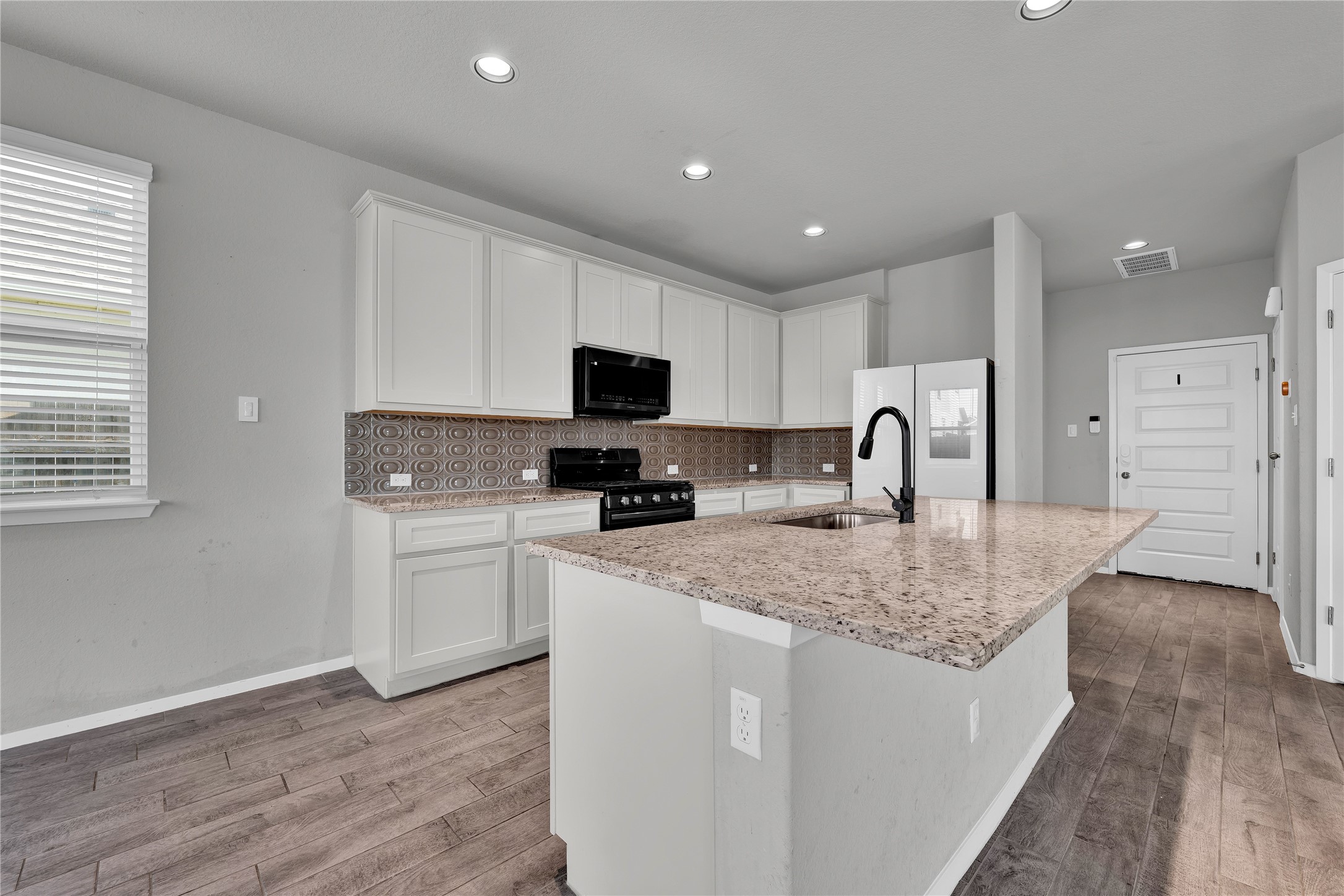 101 Crescent Street Georgetown, TX 78626 - Photo 9 of 39 Kitchen offers ample counter space and sleek, integrated appliances.