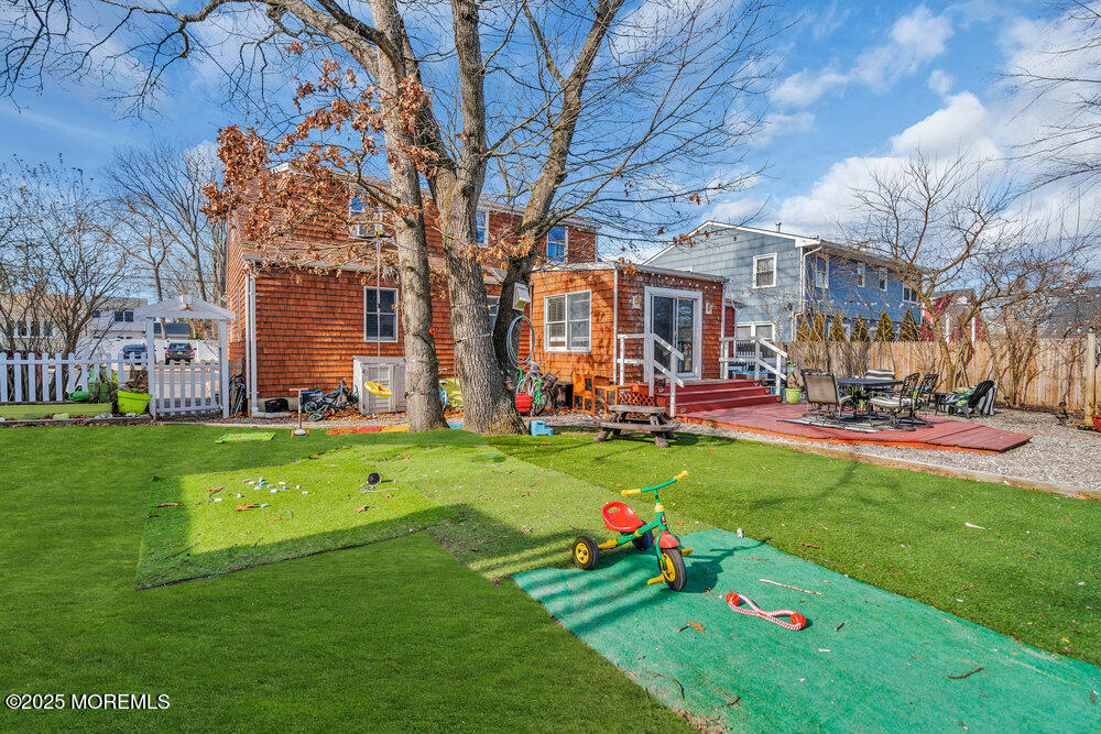 506 Crestview Terrace Point Pleasant, NJ 08742 - Photo 22 of 24 a front view of a house with a big yard and a large tree
