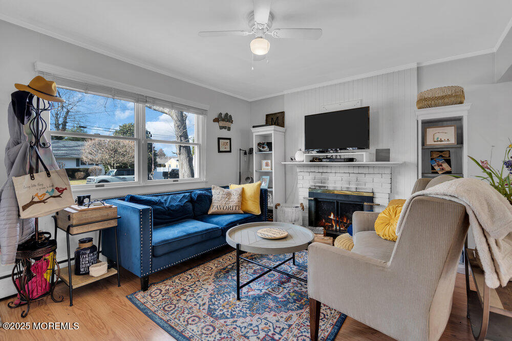 506 Crestview Terrace Point Pleasant, NJ 08742 - Photo 3 of 24 a living room with furniture a flat screen tv and a fireplace