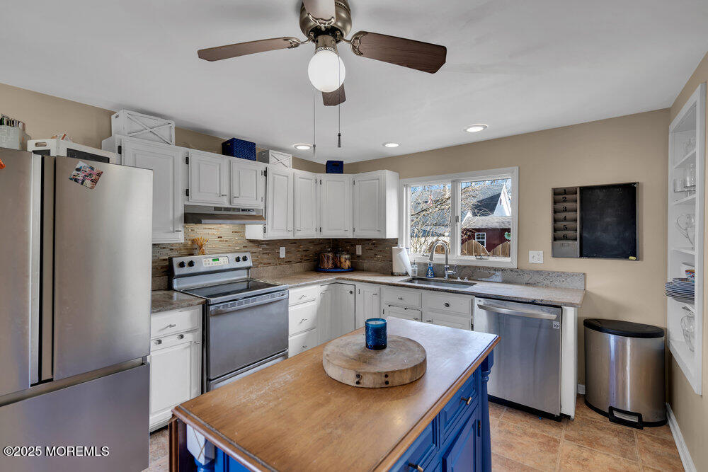 506 Crestview Terrace Point Pleasant, NJ 08742 - Photo 6 of 24 a kitchen with stainless steel appliances granite countertop a sink a stove a refrigerator cabinets and a dining table
