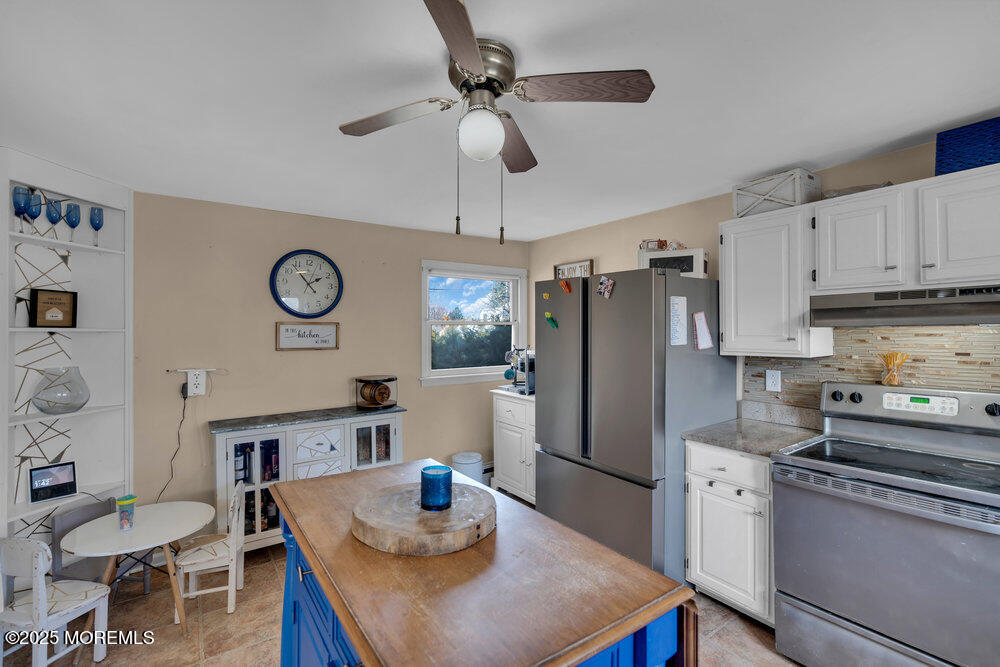 506 Crestview Terrace Point Pleasant, NJ 08742 - Photo 9 of 24 a kitchen with stainless steel appliances granite countertop a sink a stove a dining table and chairs