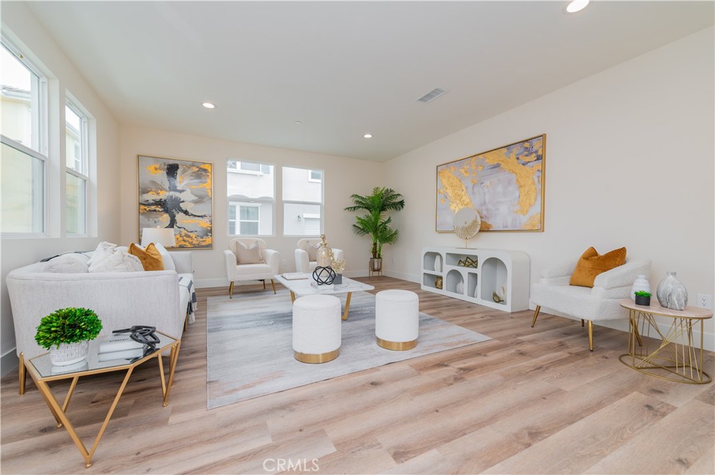 11237 Gladhill Road, Unit 10 Whittier, CA 90604 - Photo 2 of 9 a view of a dining room with furniture a potted plant and wooden floor
