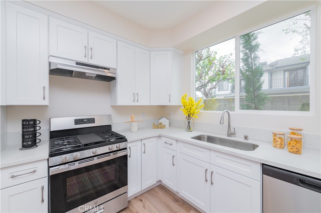 11237 Gladhill Road, Unit 10 Whittier, CA 90604 - Photo 5 of 9 a kitchen with granite countertop a sink stainless steel appliances and cabinets