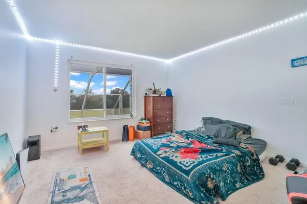 a bedroom with a large bed and a window