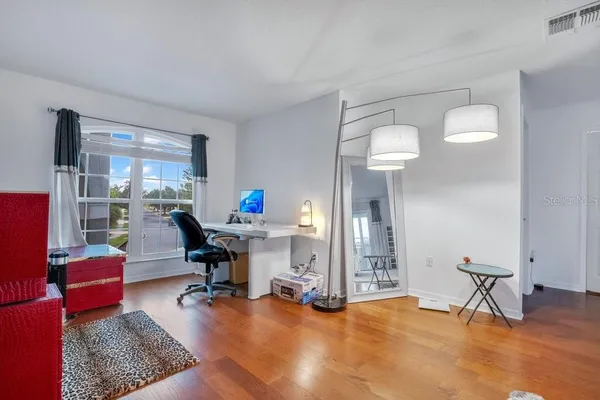 a bedroom with a large bed and a flat tv screen