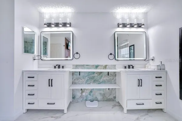 a bathroom with a double vanity sink mirror and double