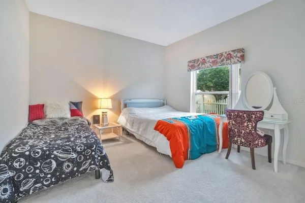 a bedroom with furniture and a window