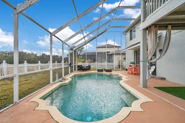 a view of a swimming pool with an outdoor space and seating area