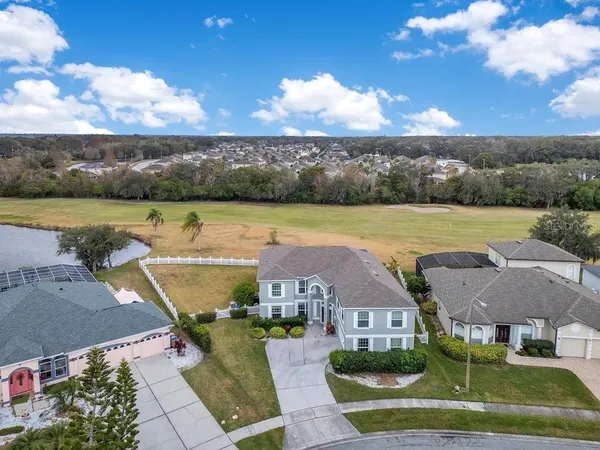 an aerial view of a house with a lake view