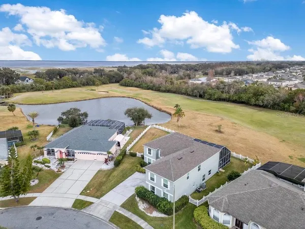 an aerial view of a house with a lake view