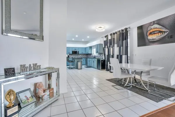 a kitchen with sink a microwave and cabinets