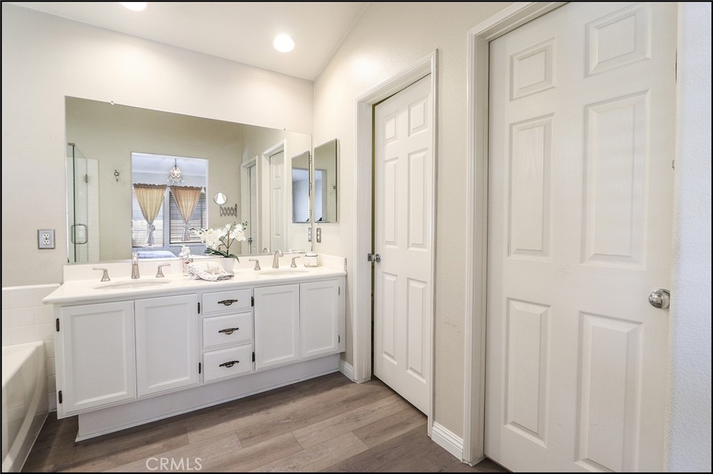 3 Delfin Aliso Viejo, CA 92656 - Photo 12 of 23 a bathroom with a double vanity sink a mirror and a bathtub