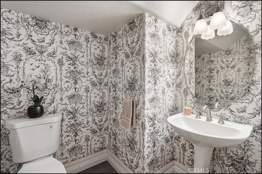 3 Delfin Aliso Viejo, CA 92656 - Photo 20 of 23 a bathroom with a sink and mirror with toilet