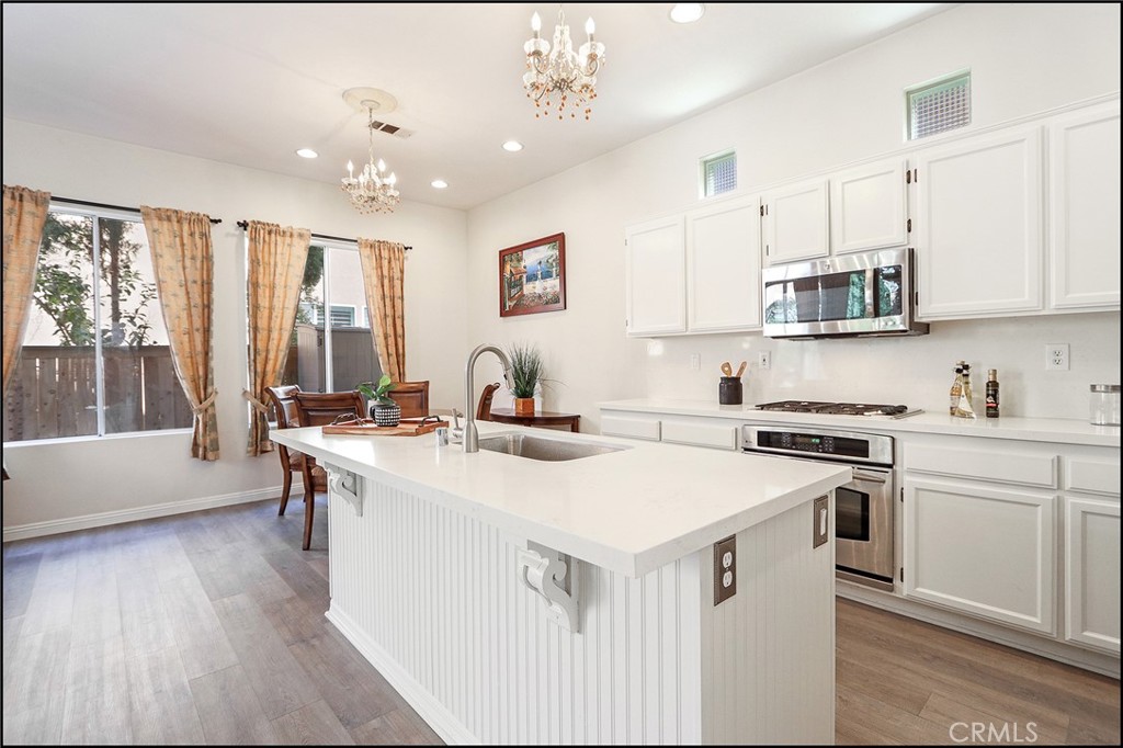 3 Delfin Aliso Viejo, CA 92656 - Photo 5 of 23 a kitchen with a stove a sink and a refrigerator