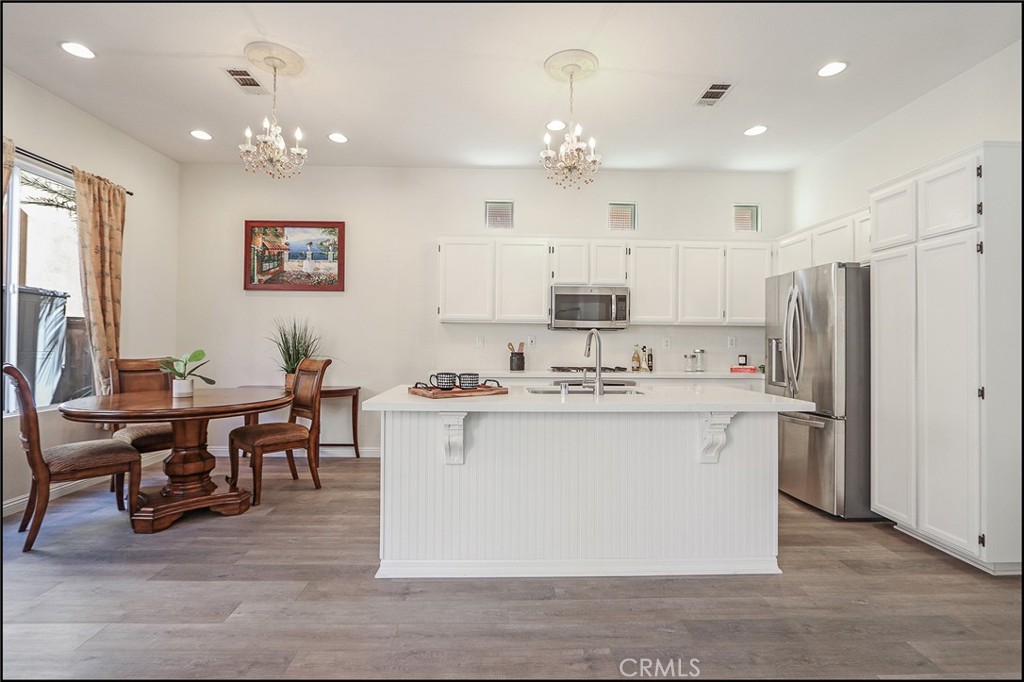 3 Delfin Aliso Viejo, CA 92656 - Photo 7 of 23 a view of kitchen with stainless steel appliances granite countertop a sink a stove a refrigerator and island with wooden floor