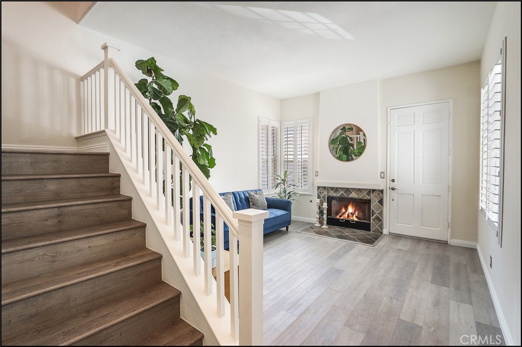 3 Delfin Aliso Viejo, CA 92656 - Photo 9 of 23 a view of an entryway with wooden floor and a bookshelf