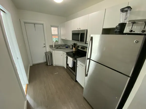 a kitchen with a refrigerator a stove top oven a sink and dishwasher