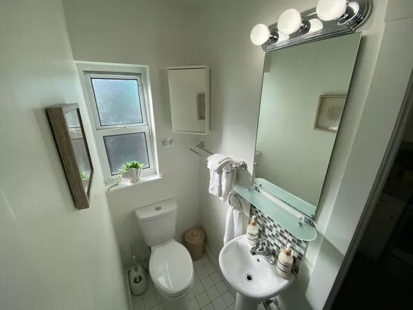 a bathroom with a toilet a sink and mirror