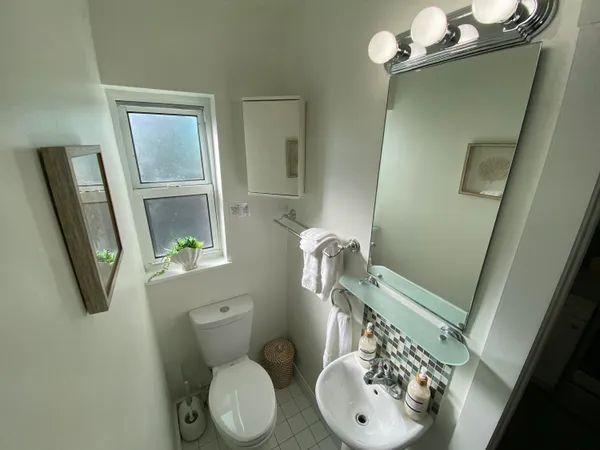 a bathroom with a toilet sink and mirror
