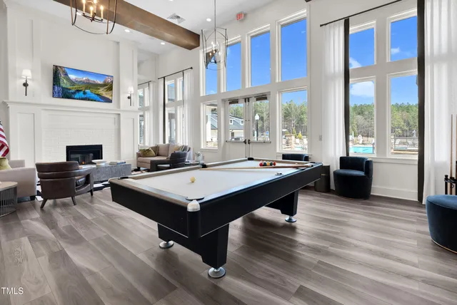 a living room with stainless steel appliances granite countertop furniture a fireplace and a large window