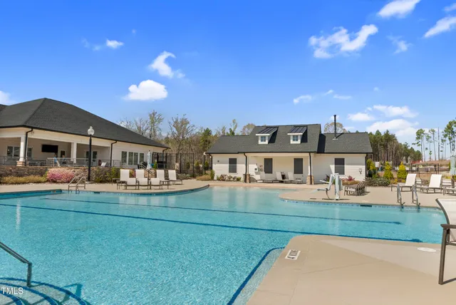 a front view of residential houses with yard and green space
