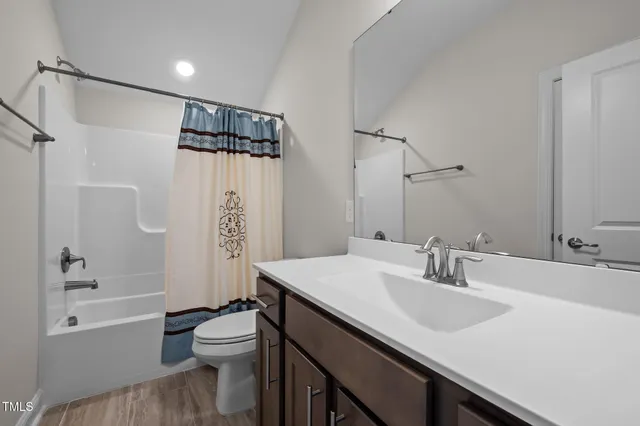 a bathroom with a sink toilet tub and shower