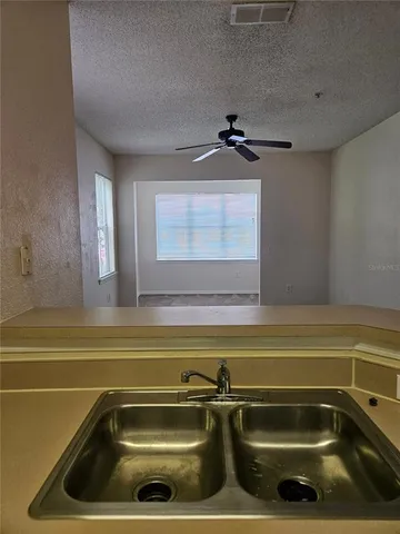 a view of a kitchen counter top a sink and dishwasher with wooden floor