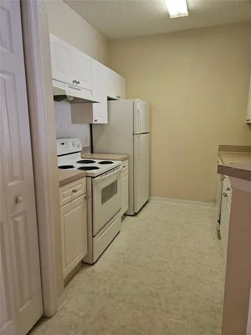 a kitchen with a stove a sink and a refrigerator