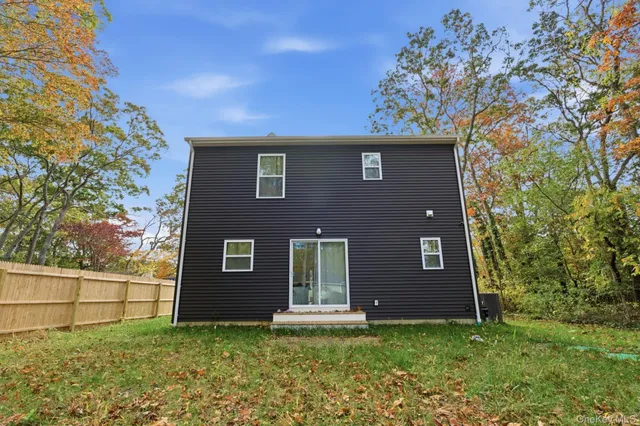 a house that has a tree in front of it