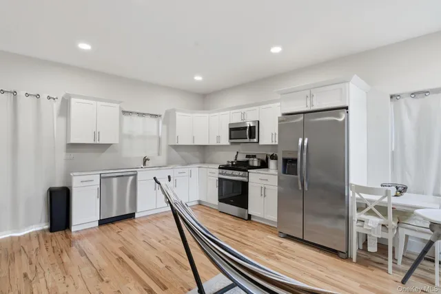 a kitchen with stainless steel appliances a refrigerator stove microwave and cabinets