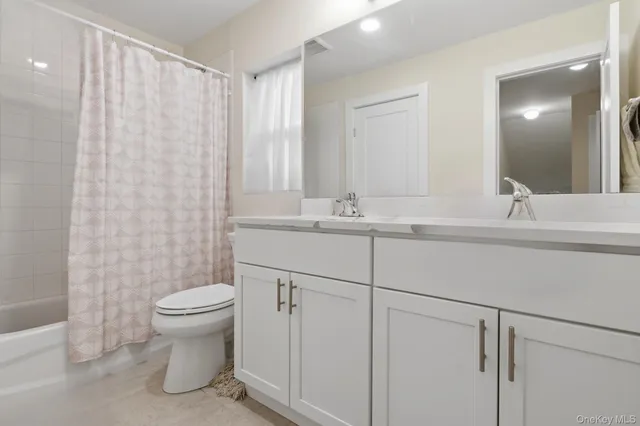 a bathroom with a sink toilet and mirror