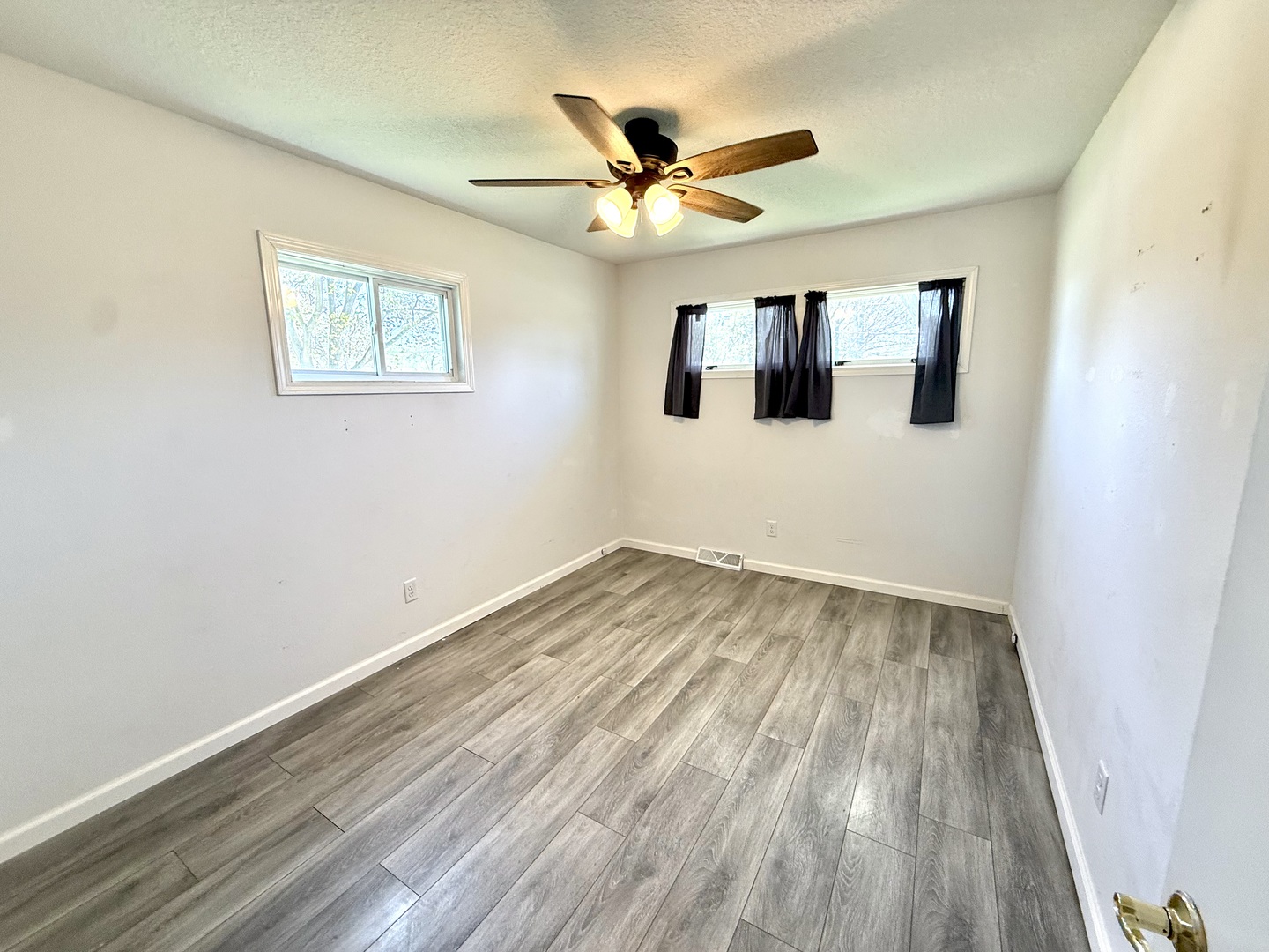 207 East Illinois Street Cambridge, IL 61238 - Photo 11 of 29 a view of a room with wooden floor and ceiling fan