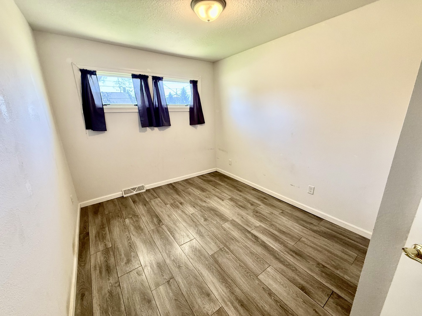 207 East Illinois Street Cambridge, IL 61238 - Photo 17 of 29 a view of a room with wooden floor and cabinet