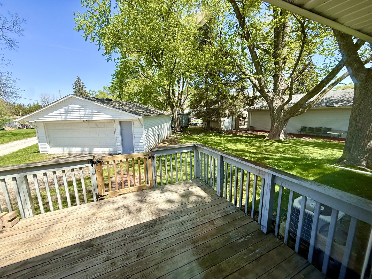 207 East Illinois Street Cambridge, IL 61238 - Photo 23 of 29 a view of a wooden deck and trees with wooden fence