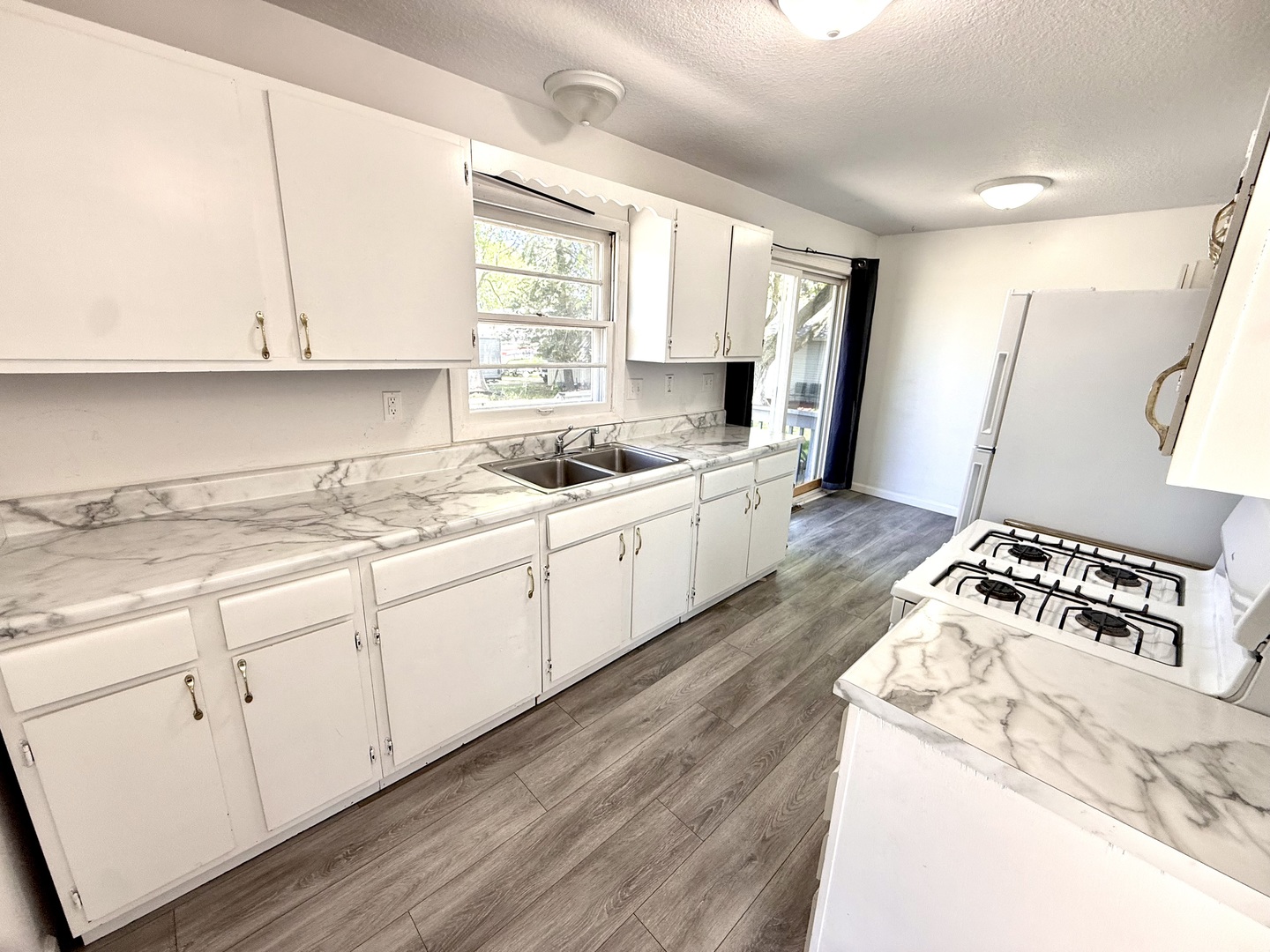 207 East Illinois Street Cambridge, IL 61238 - Photo 4 of 29 a kitchen with a sink stove and cabinets
