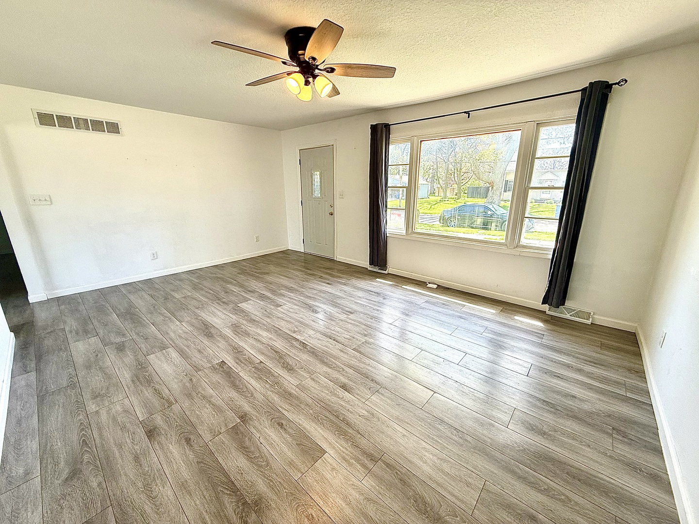 207 East Illinois Street Cambridge, IL 61238 - Photo 9 of 29 a view of empty room with wooden floor and fan