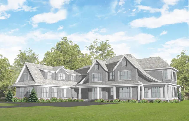 a view of a white house next to a yard with big trees