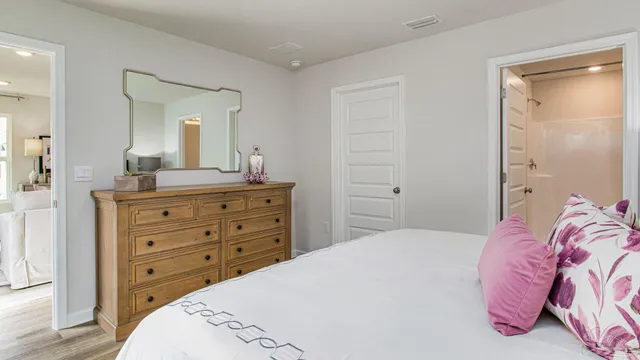 a bedroom with a bed and a dresser