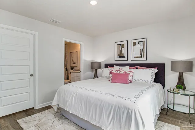 a bedroom with a bed and a night stand